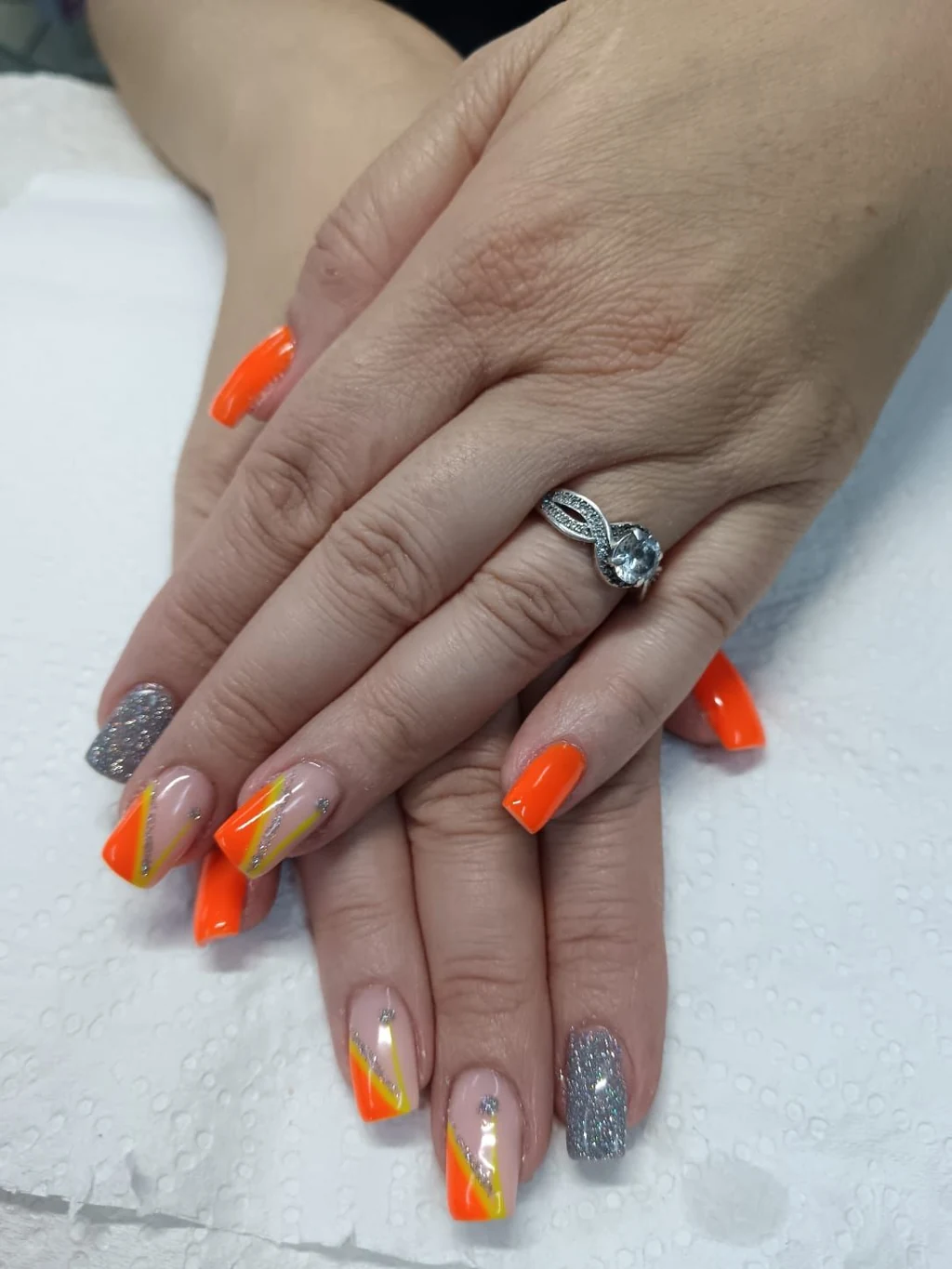 Nails done at Neon Moon Nail & Beauty, Sasolburg: neon orange with a silver glitter nail